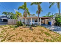 Charming light blue single story home with front porch and well-manicured front yard at 513 25Th W Ave, Bradenton, FL 34205