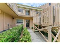Welcoming front entrance with well-maintained landscaping and private entrance to the home's upper level at 6030 7Th W Ave # 6030, Bradenton, FL 34209