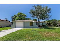 Charming single-story home featuring a well-maintained lawn, attached garage and tasteful landscaping at 8730 Filson Pl, Sarasota, FL 34231