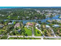 Expansive aerial view of waterfront property with lush landscaping and private canal access at 1475 Bayshore Dr, Englewood, FL 34223