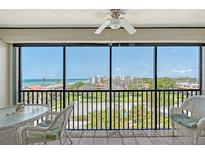 Enjoy the ocean view from this screened balcony with wicker furniture and beautiful tile flooring at 2045 Gulf Of Mexico Dr # M1-515, Longboat Key, FL 34228