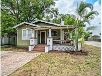 Charming bungalow-style home featuring a covered front porch and well-maintained landscaping at 301 W South Ave, Tampa, FL 33603