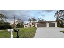 Charming single-story home with a well-manicured lawn and a two-car garage showcases a modern design at 3386 Irma St, North Port, FL 34291
