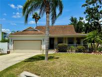 Charming single-story home with manicured lawn, mature landscaping and an attached two car garage at 3828 6Th W Ave, Palmetto, FL 34221