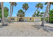 Charming home featuring a well-maintained exterior, manicured landscaping, and a welcoming front entrance at 385 Avenida Madera, Sarasota, FL 34242