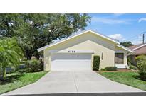 Inviting single-story home featuring an attached two-car garage and concrete driveway at 4109 Carriage Dr # 23, Sarasota, FL 34241