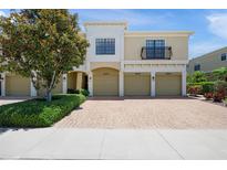 Three-unit townhouse building featuring tan stucco and a brick driveway at 4204 Overture Cir # 4204, Bradenton, FL 34209