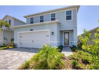 Charming two-story home features a two-car garage, beautiful landscaping, and a welcoming entrance at 4524 Pippin Ln, Lakewood Ranch, FL 34211