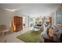 Inviting living room with serene decor, plush sofas, and a view to the lanai at 4530 Pinebrook Cir # 109, Bradenton, FL 34209