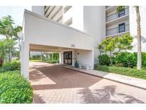 Building entrance featuring covered parking and well-maintained landscaping at 9393 Midnight Pass Rd # 603, Sarasota, FL 34242