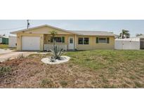 Charming single-story home featuring yellow siding, a one-car garage, and a well-maintained front yard at 1190 Jamaica Rd, Venice, FL 34293