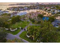 Stunning waterfront property featuring a beautifully landscaped yard, a tennis court, and a luxurious home with beautiful palm trees at 1423 & 1435 Hillview Dr, Sarasota, FL 34239
