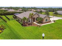 Well-maintained lawn and landscaping enhance this charming single-story home's curb appeal at 16246 26Th E St, Parrish, FL 34219