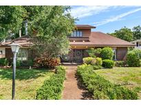 Charming two-story home with a well-manicured front yard and a welcoming front porch at 1671 South Dr, Sarasota, FL 34239