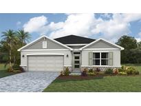 Inviting single-story home with a two-car garage, stone accents, well-manicured lawn, and lush landscaping at 1758 Cobb Trl, Parrish, FL 34219