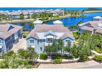 Charming two-story coastal home featuring a lake view and lush landscaping in a desirable neighborhood at 262 Sapphire Lake Dr # 202, Bradenton, FL 34209