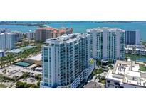 Aerial view of the luxury high-rise featuring stunning architecture and water views at 301 Quay Commons # 1208, Sarasota, FL 34236