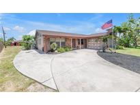 Charming single-story home with brick accents, a spacious driveway, and manicured landscaping at 3311 Florida Blvd, Bradenton, FL 34207