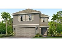 Charming two-story home featuring neutral color, symmetrical shutters, and lush tropical landscaping at 5046 Rocky Coast Pl, Palmetto, FL 34221