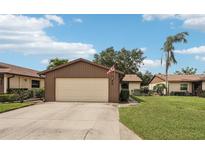 Charming single-story home featuring a two-car garage, well-maintained lawn, and mature landscaping at 532 Oak Hill Cir # 12, Sarasota, FL 34232