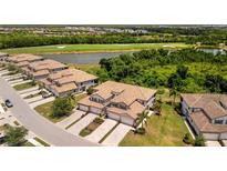 Beautiful home with lush landscaping, tile roof, and paver driveway; backing up to a golf course and pond at 5843 Wake Forest Run # 104, Bradenton, FL 34211