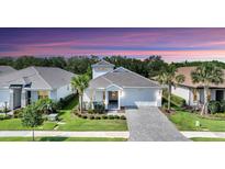Charming single-story home boasts a well-manicured lawn, a brick driveway and a two-car garage at 8069 Tidal Pointe Way, Sarasota, FL 34240