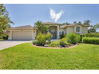Charming single-story home featuring lush landscaping and a well-manicured lawn at 9016 30Th E St, Parrish, FL 34219