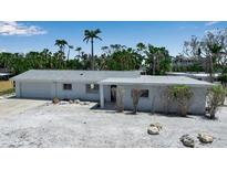 Charming single-story home with a clean design, complemented by tropical landscaping and a well-maintained front yard at 130 N Adams Dr, Sarasota, FL 34236