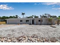 Charming single-story home with a garage and a landscaped front yard featuring decorative stones at 130 N Adams Dr, Sarasota, FL 34236