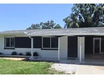 Charming single story home featuring a covered front porch and well-maintained lawn at 3730 Ferguson St, Sarasota, FL 34233