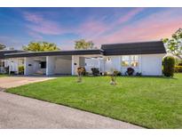 Charming single-story home with a carport and well-manicured front lawn in a quiet neighborhood at 3816 Blue Stone Way # 97, Sarasota, FL 34232