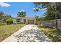 Charming single-story home featuring a well-maintained front yard, a driveway and a one car garage at 4251 Austin St, Sarasota, FL 34233