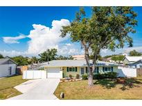 Charming single-story home with a well-maintained lawn, mature tree, and attached one car garage at 4375 Tortoise Rd, Venice, FL 34293