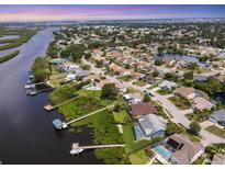 Scenic aerial view of waterfront homes, docks, and lush landscaping along the canal and neighborhood at 4844 14Th E Ave, Bradenton, FL 34208