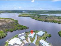 Stunning aerial view of waterfront home with private dock and lush landscaping at 550 Tampico Dr, North Port, FL 34287