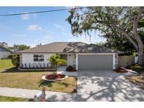 Charming single-story home with a well-maintained lawn, decorative landscaping, and a two-car garage at 6572 Mauna Loa Blvd, Sarasota, FL 34241