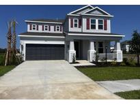 Charming two-story home with manicured lawn, inviting porch and a two car garage at 8583 Big Dipper Dr, Sarasota, FL 34241