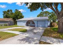 Charming single-story home with a well-maintained front yard and a private driveway at 1035 Axlewood Cir, Brandon, FL 33511