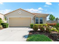 Charming single-story home with manicured landscaping and a two-car garage at 138 Tiziano Way, North Venice, FL 34275