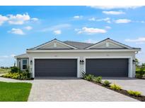 Charming home featuring a two-car garage and a well-manicured lawn at 3204 Torta Ct, Bradenton, FL 34211