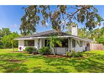 Charming home with brick facade, well-manicured lawn, landscaping and wrought iron details in a lush, mature setting at 326 25Th W St, Bradenton, FL 34205