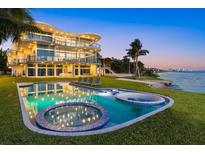 Stunning waterfront home with a luxurious pool, hot tub, and spacious outdoor lounging area at 4035 Bay Shore Rd, Sarasota, FL 34234