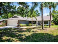 Charming single-story home featuring lush landscaping, a two-car garage, and a welcoming front entrance at 4253 Prairie View Dr, Sarasota, FL 34232