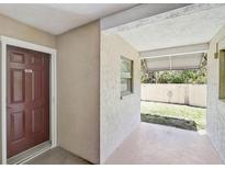 Inviting front porch with a covered area, perfect for enjoying the outdoors at 7211 Cloister Dr # 101, Sarasota, FL 34231