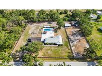 Expansive property featuring a pool, outbuildings, and a well-maintained home with lush landscaping, offering privacy and space at 2255 61St St, Sarasota, FL 34243