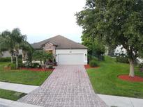 Charming single-story home with brick-paved driveway, stone accents, and lush landscaping at 2334 50Th Street E Cir, Palmetto, FL 34221