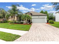 Beautiful single-story home featuring a two-car garage, stone accents, and lush landscaping at 2334 50Th Street E Cir, Palmetto, FL 34221