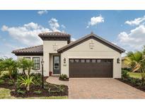 Charming single-story home with a well-manicured lawn and a two-car garage at 26687 Raphis Royale Blvd, Englewood, FL 34223