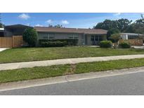 Charming single-story home with well-maintained lawn and mature landscaping at 3060 Courtland St, Sarasota, FL 34237