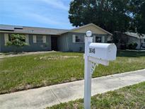 Charming one-story home with a green lawn and neatly trimmed shrubs, complemented by a white mailbox at 3646 Lakewood Dr, Sarasota, FL 34232